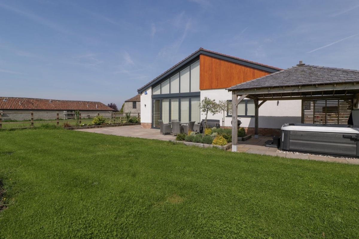 Bilsham Meadows lawn, modern house and covered hot tub gazebo