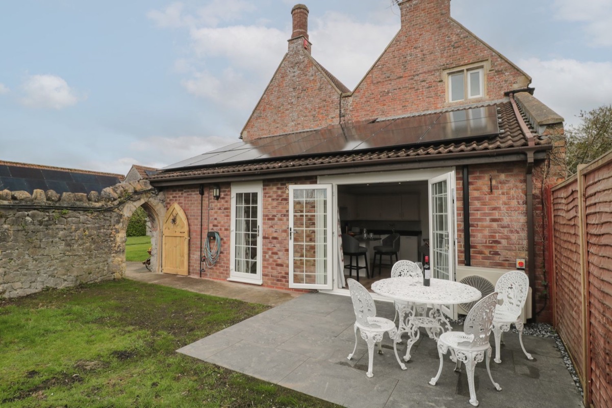 The Hideaway patio seating outside the brick house in Lympsham